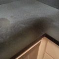 Dull Black Corian Countertop before Cleaning and Shining Up