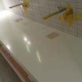 Polished Dupont Corian Countertop in Restroom